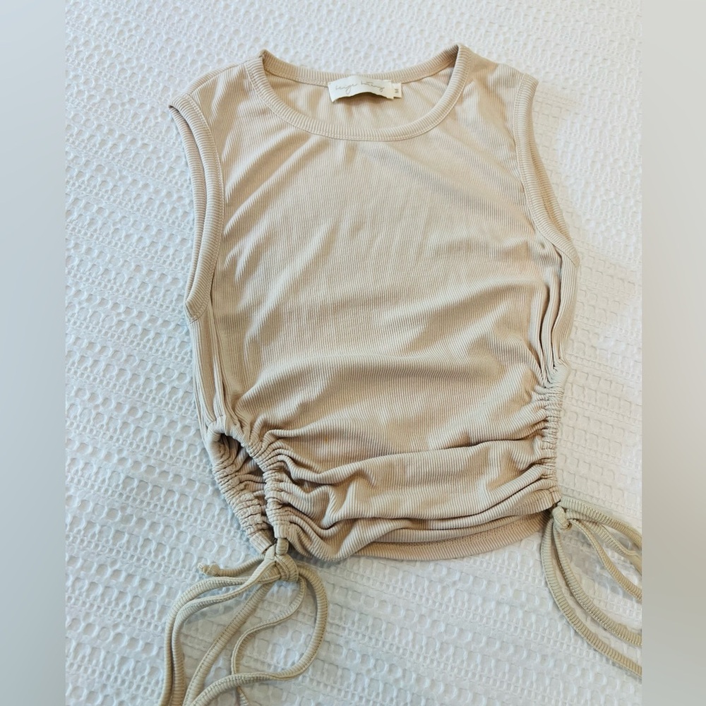 Chic Beige Sleeveless Top with Drawstring Details on the side.